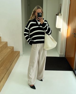 Woman wearing a striped sweater and khaki pants