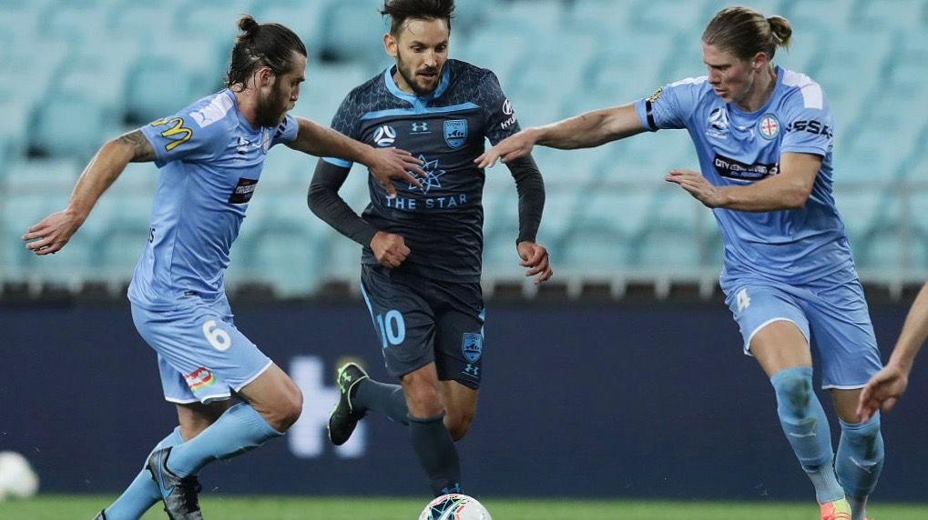 Milos Ninkovic of Sydney FC is tackled by Harrison Delbridge and Josh Brillante of Melbourne City