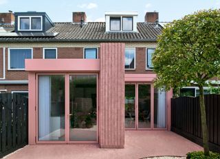 a home extension with a pink color wall, ceiling, doors, and patio