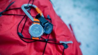 COROS VERTIX review: watch fastened to a backpack using a carabiner