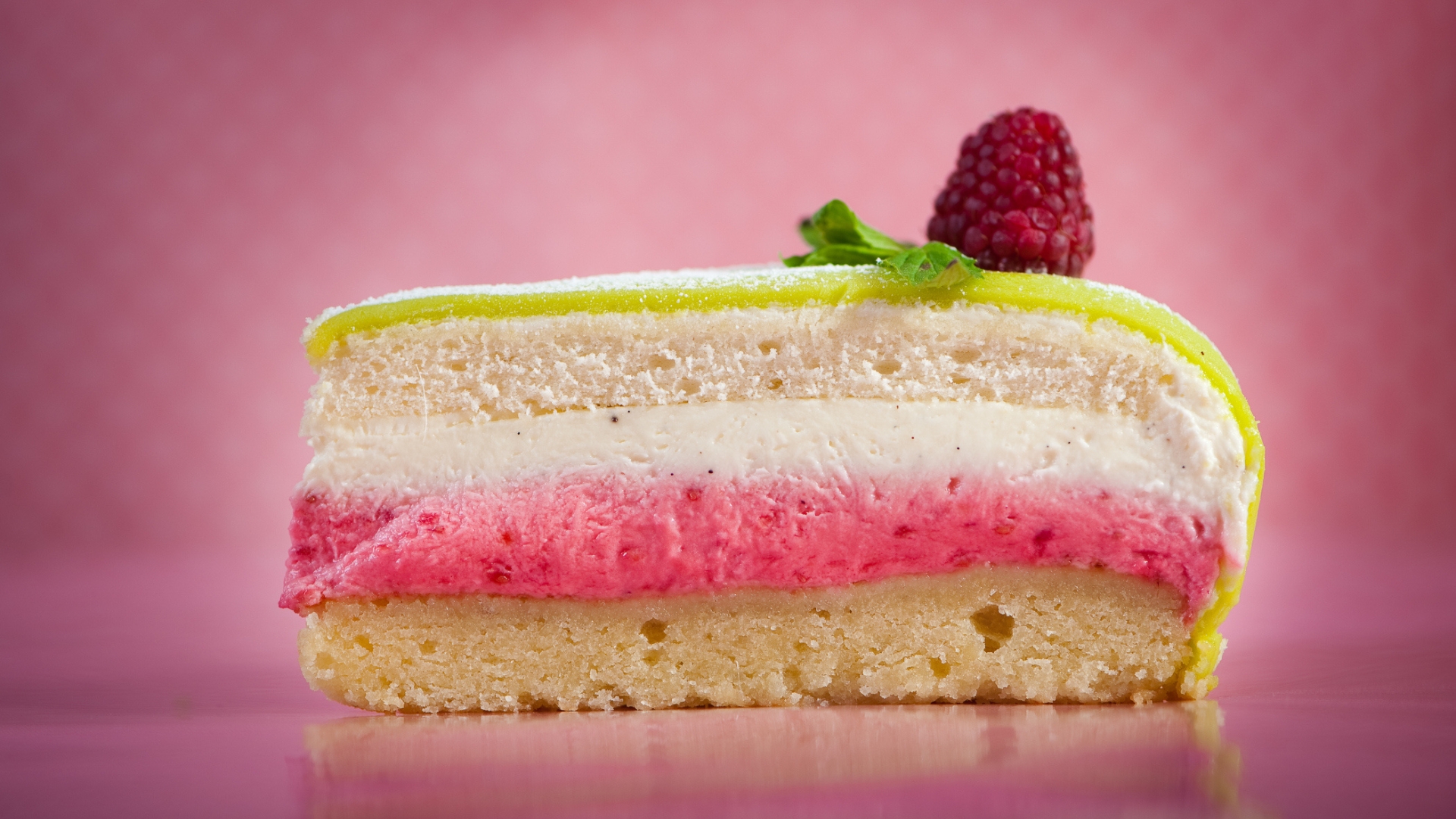 Sweden's Prinsesstårta (Princess Cake) is pastel green and topped with a pink sugar rose, and is made of layers of light sponge, vanilla custard, raspberry jam, and whipped cream, all wrapped in a smooth dome of marzipan.