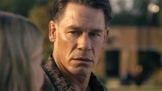 A close up of Chris Smith looking at Emilia Harcourt in Peacemaker season 2 episode 5