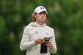 Cedric Gugler holds his yardage book