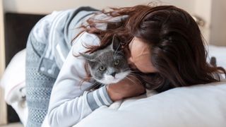 Woman cuddling cat