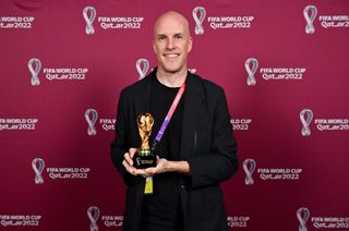 Grant Wahl with a world cup replica trophy, in recognition of their achievement of covering 8 or more FIFA World Cups, during an AIPS / FIFA Journalist on the Podium ceremony at the Main Media Centre on November 29, 2022
