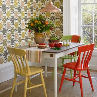 dining area with dining table and chair andd floral wallpaper wall