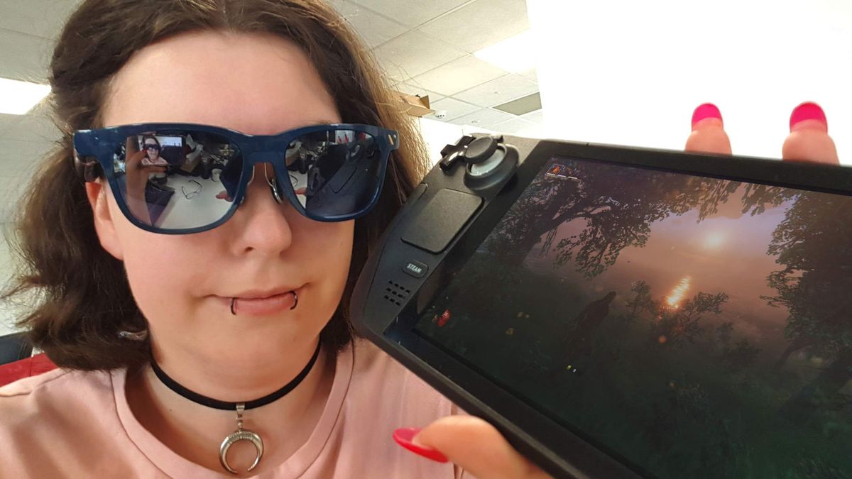 Katie wearing Virture XR goggles holding a Steam Deck