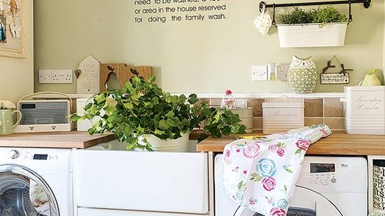 laundry room with two washing machine and cabinet