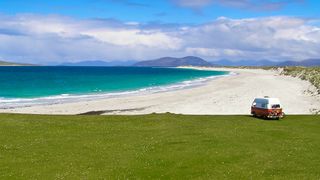 Vw camper van overlooking beach on Isle of Bernerary, Western Isles, Scotland