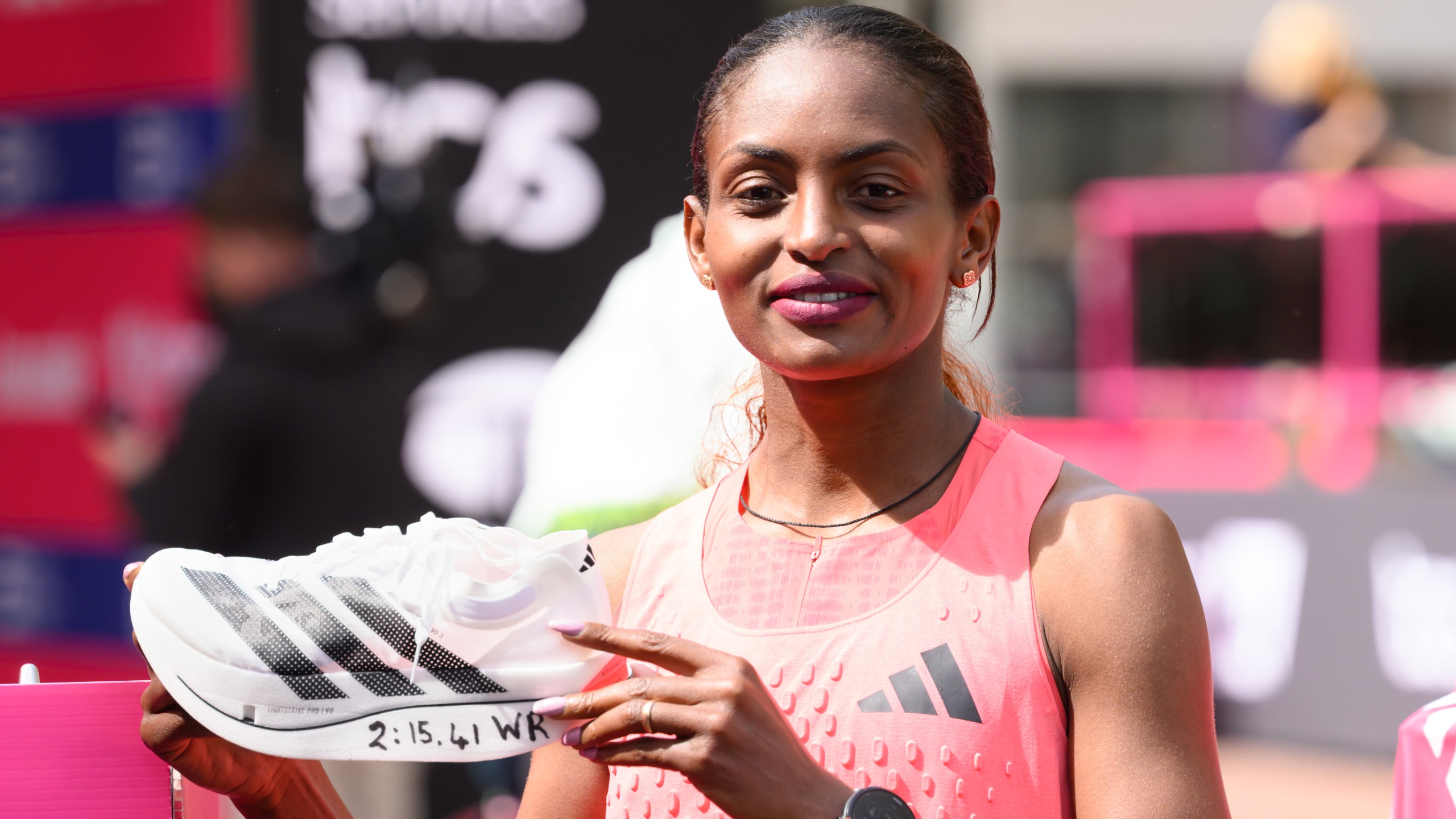 Tigst Assefa of Team Ethiopia celebrates with her adidas shoe after winning with a new World Record time during the Women&rsquo;s 2026 TCS London Marathon