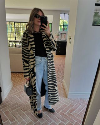 Influencer winter wishlist: @emmarosethatcher wears a zebra print coat and jeans