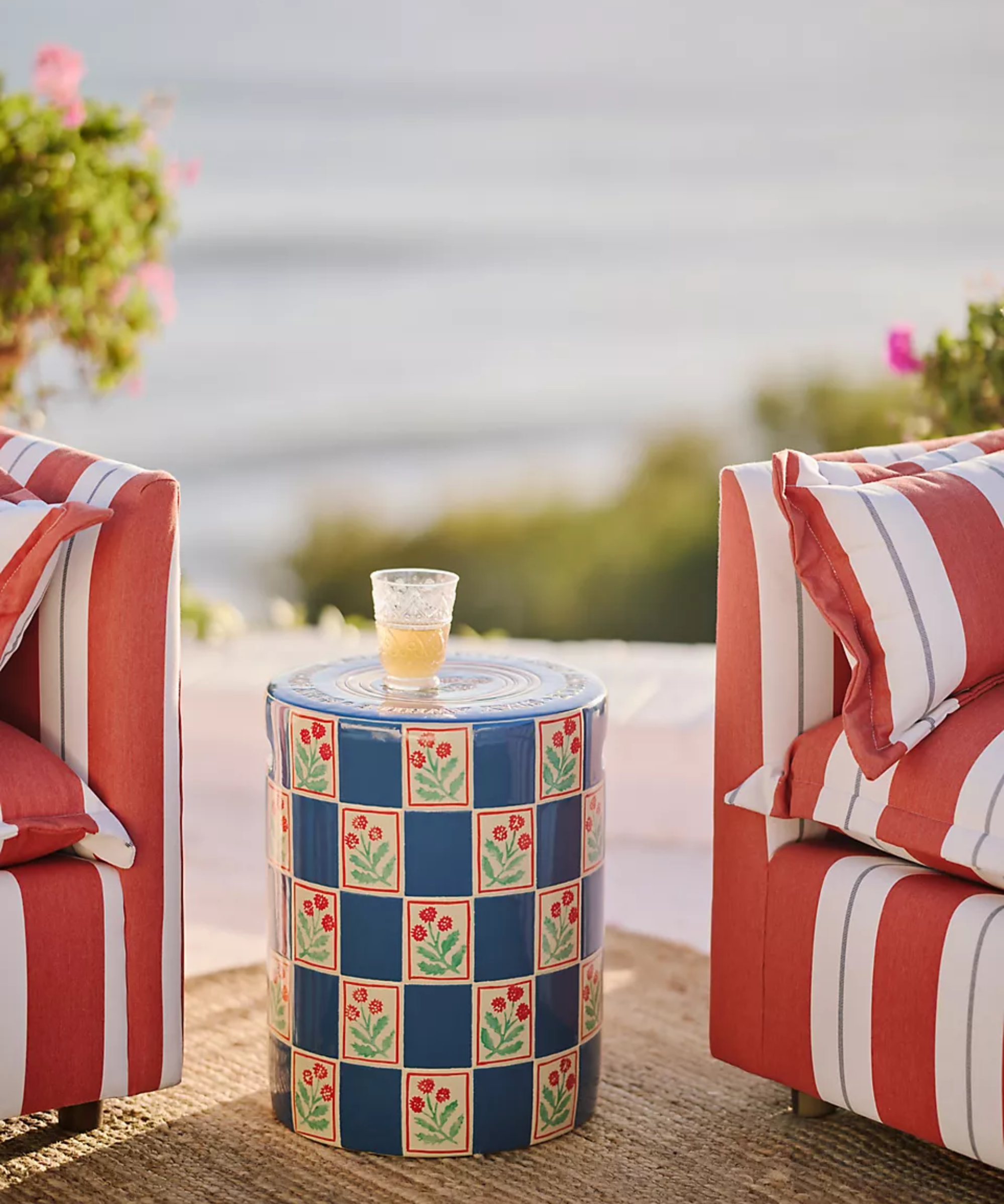 a colorful ceramic outdoor side table with decorative drawings on its sides