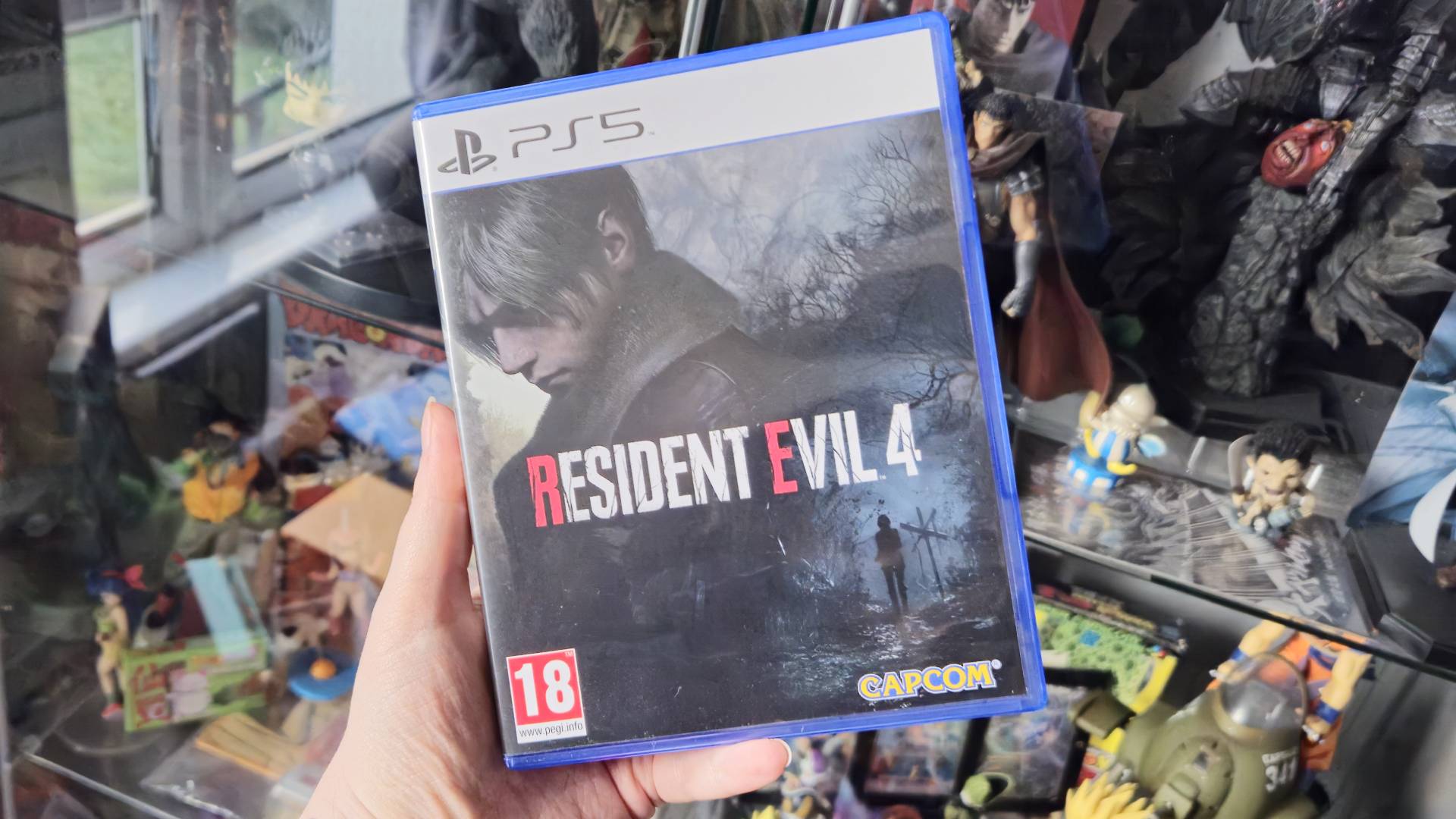 Photo of author Rosalie Newcombe holding a copy of the Resident Evil Remake for the PS5.