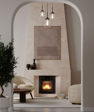 A lofty living room with a huge cream fireplace, glass statement pendant light and a log burner