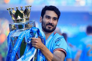 Manchester City's Ilkay Gundogan holding the Premier League trophy, 2023