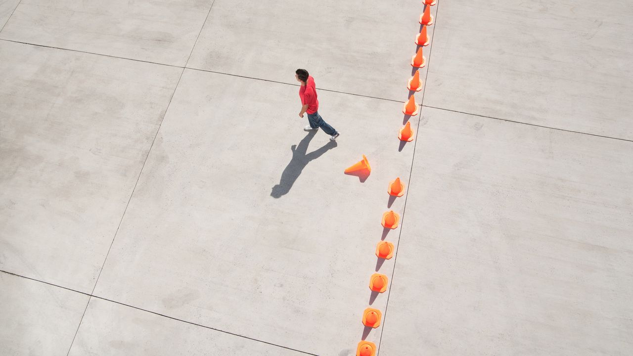 A man doesn&#039;t let orange caution cones stop her from conquering common financial biases.