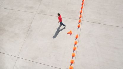 A man doesn't let orange caution cones stop her from conquering common financial biases.