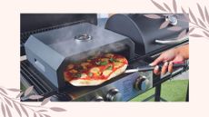 Aldi pizza oven lifestyle image of woman using pizza oven in garden