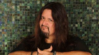 Gene Hoglan posing for a photograph with his arms folded