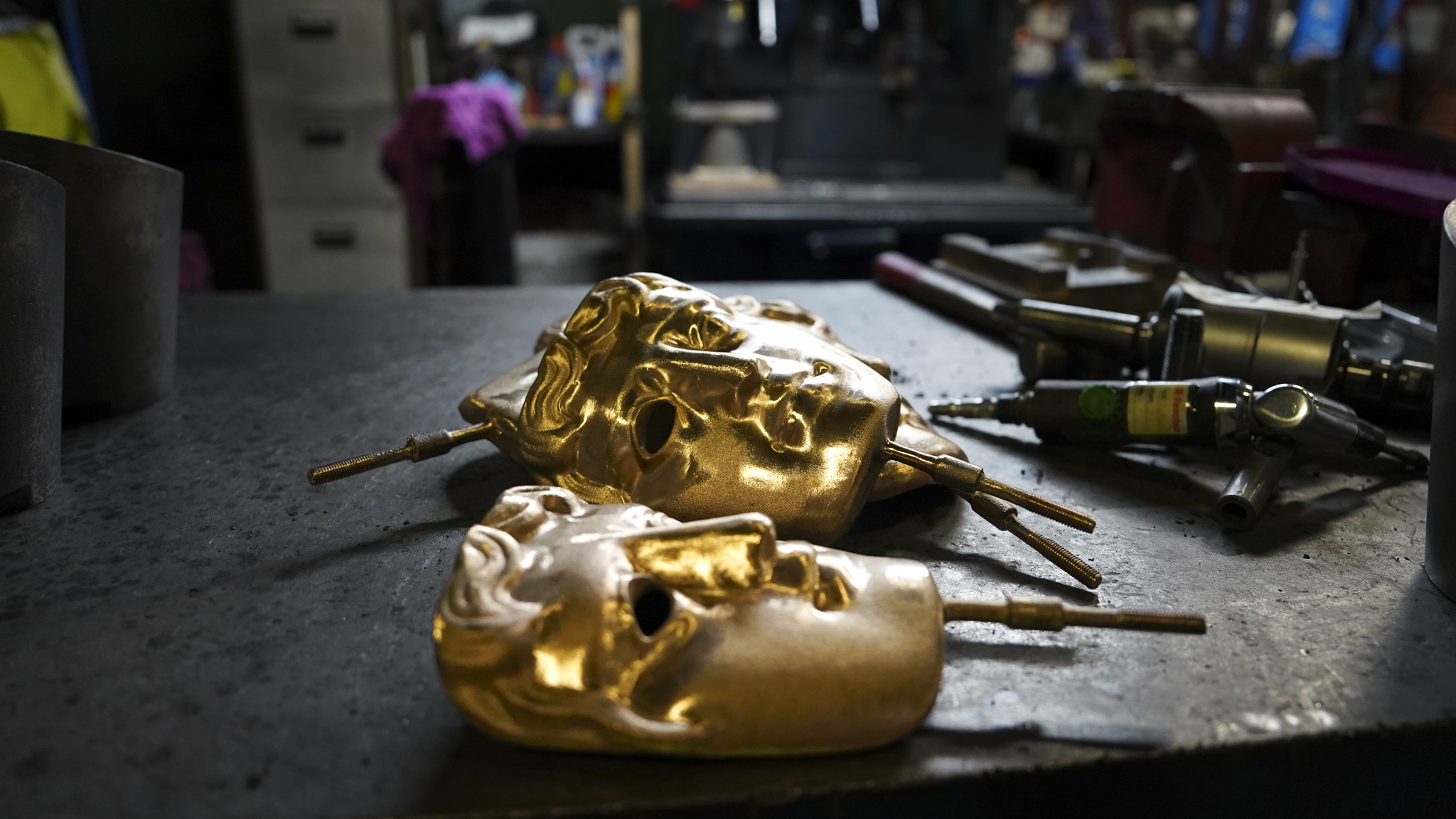 Some freshly cast BAFTAs on a table