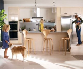 A neutral kitchen with breakfast bar and appliances