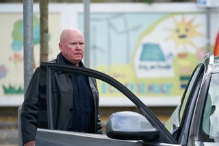 Phil Mitchell waits by his car