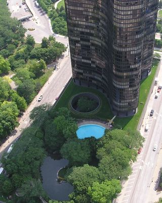 Large black skyscraper with pool