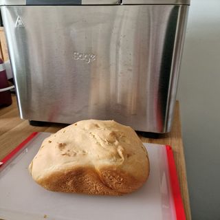Breville Custom Loaf Bread Maker with a slightly misshapen loaf next to it