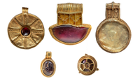 a series of five gold pendants inset with garnets