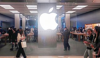 Customers experience an AI smartphone iPhone 16e at an Apple store in Shanghai, China, March 2, 2025