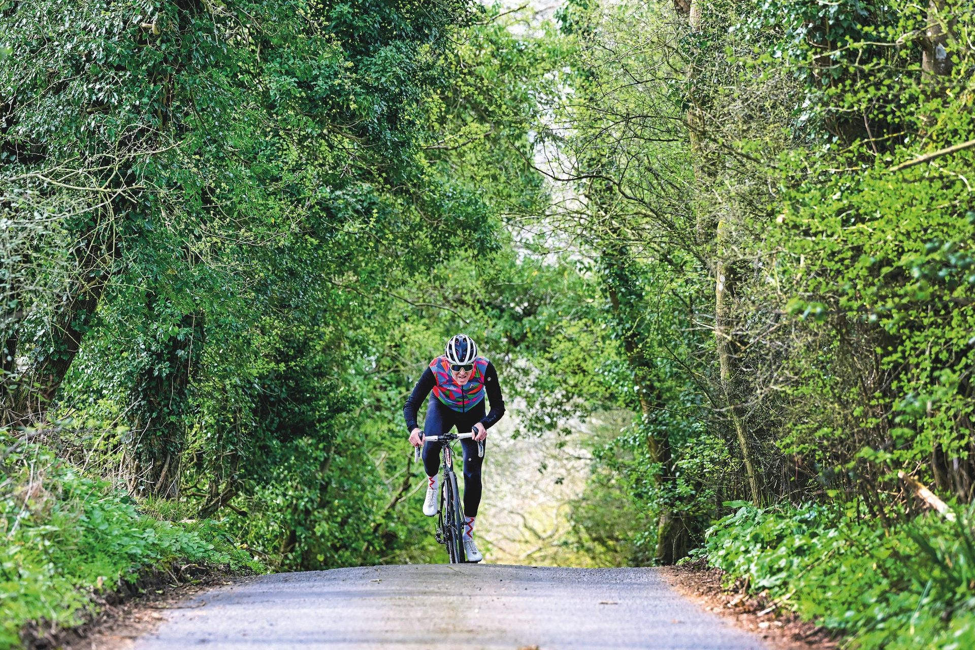 Simon Warren climbing through a corridor of trees