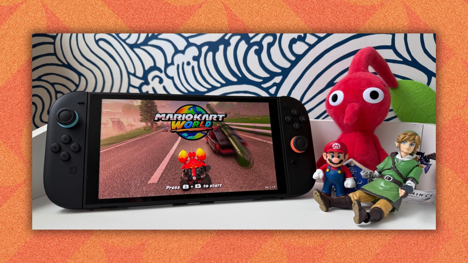 The Nintendo Switch 2 on an orange background with Nintendo character figurines around it.