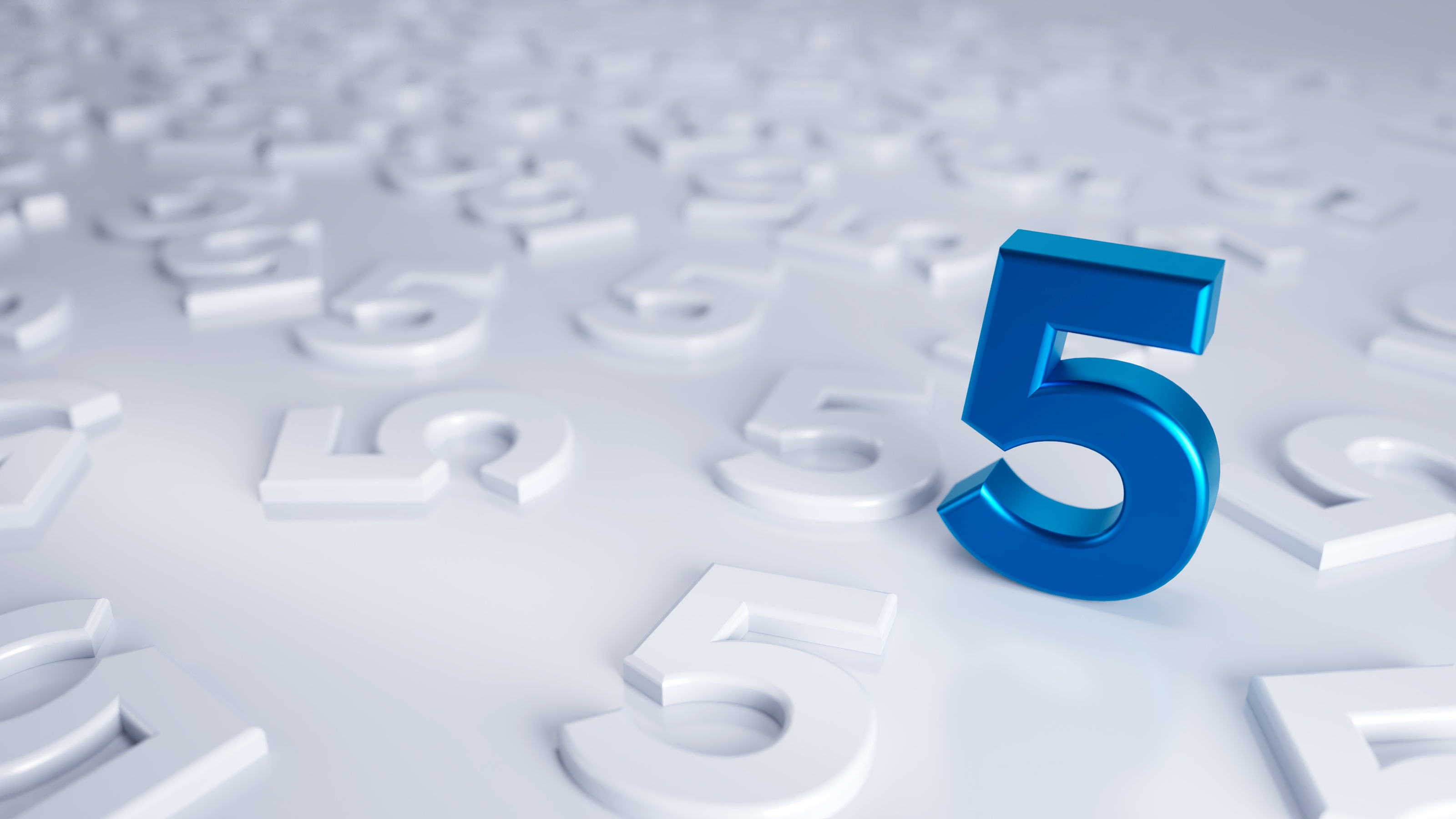 A blue number five against a background of white number fives also on a white background.