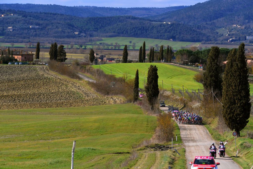 SIENA ITALY MARCH 06 The Peloton passing through Tuscany landscape during the Eroica 7th Strade Bianche 2021 Womens Elite a 136km race from Siena to Siena Piazza del Campo Landscape StradeBianche on March 06 2021 in Siena Italy Photo by Luc ClaessenGetty Images