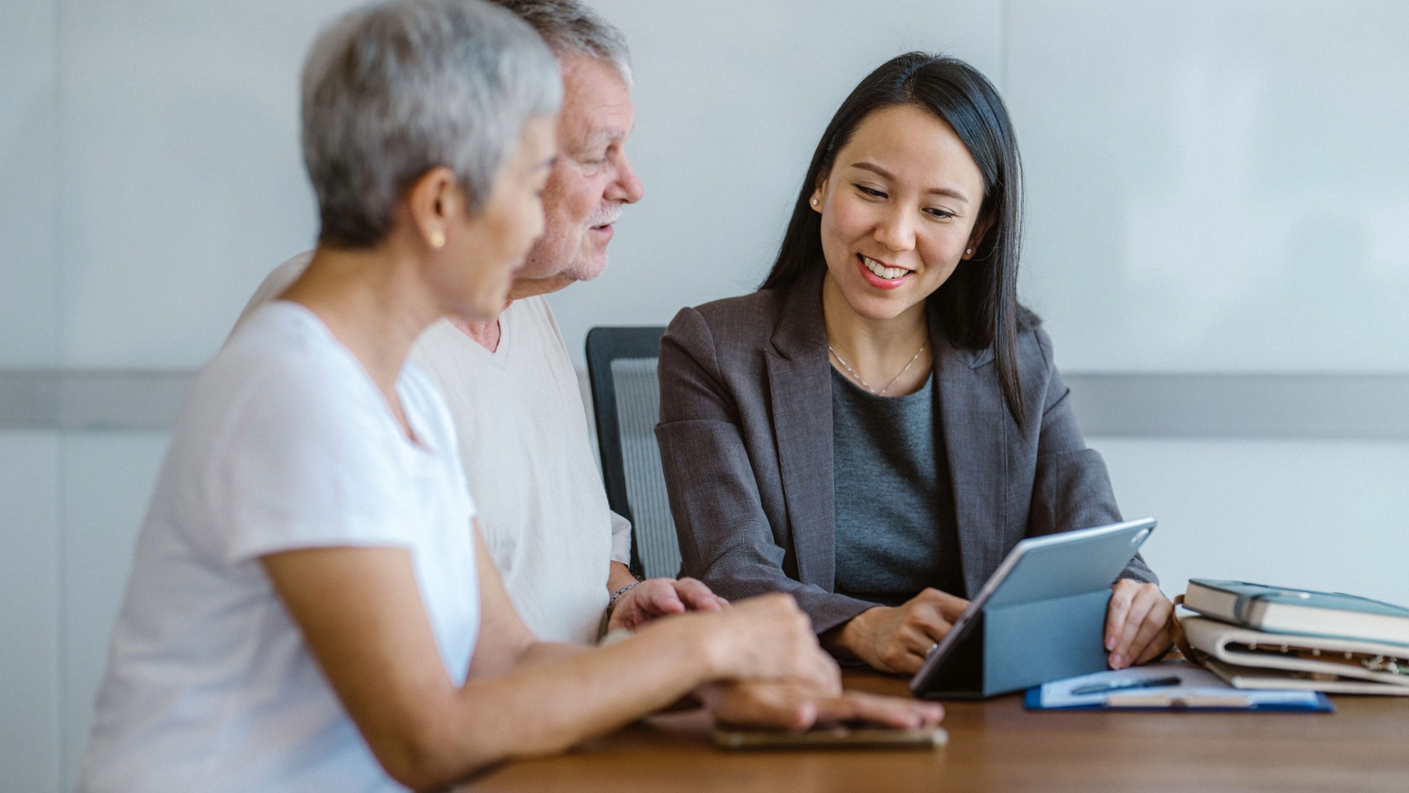 A senior couple in a meeting with their financial adviser