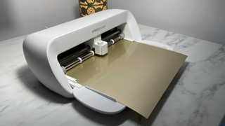 Cricut Joy Xtra review; a small white craft cutting machine on a marble table
