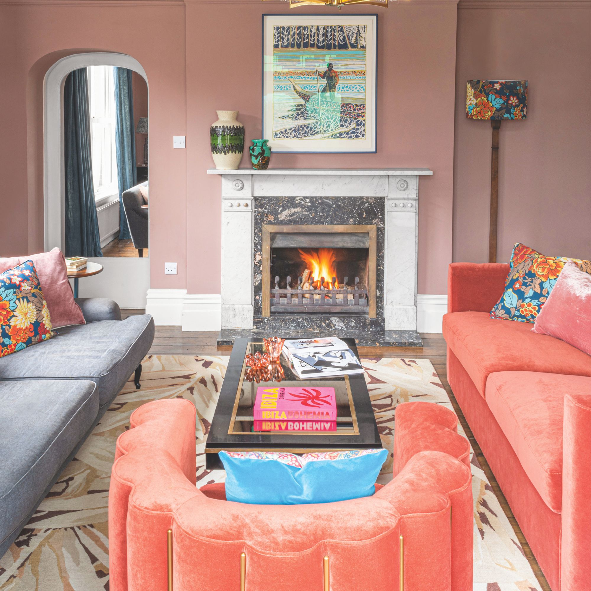 Blush pink living room with velvet orange sofas