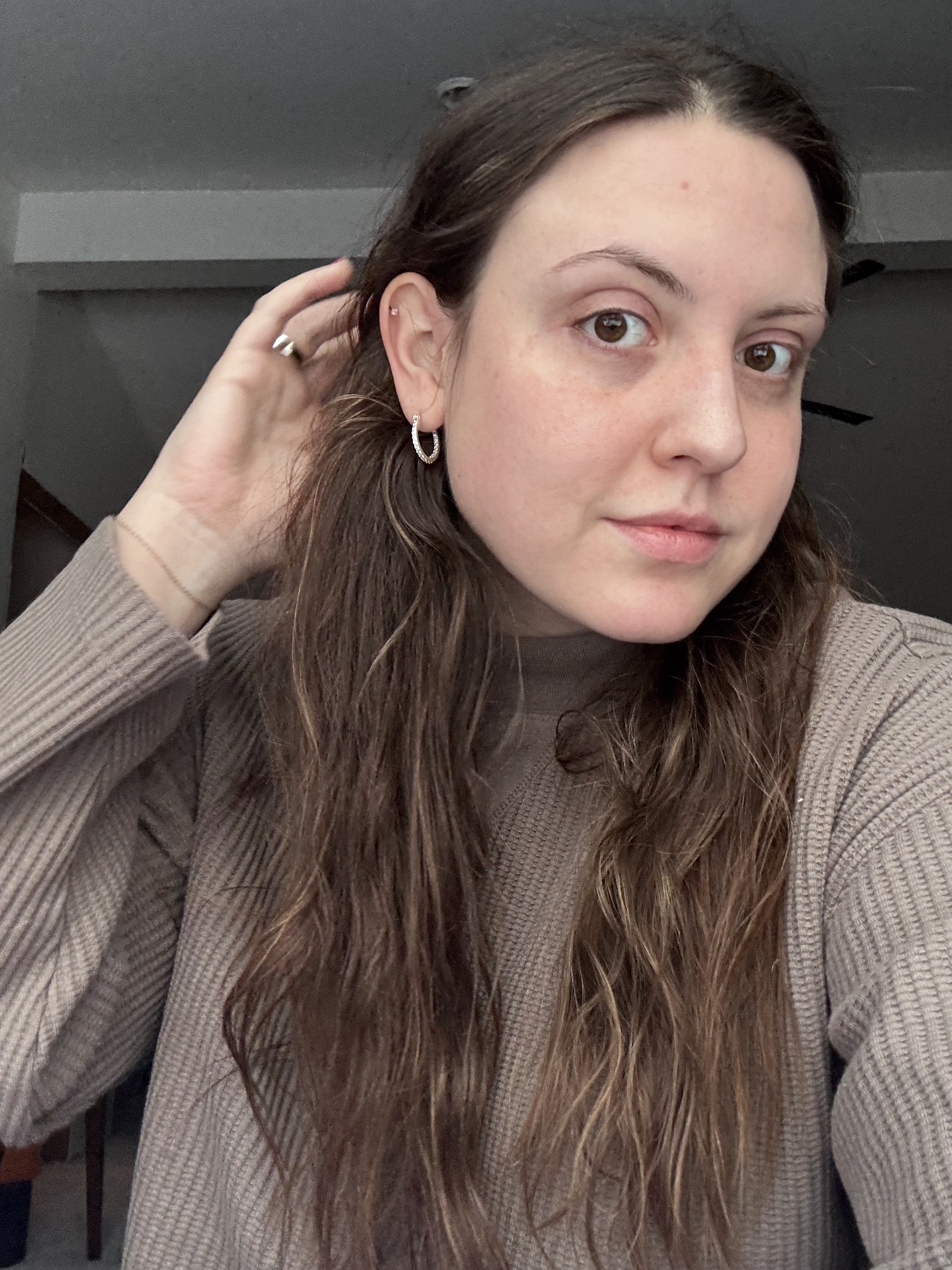 Sophia Vilensky with her waves post simple air-dry routine, wearing a brown shirt.