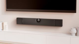 Devialet Dione hung on a wall below a TV screen