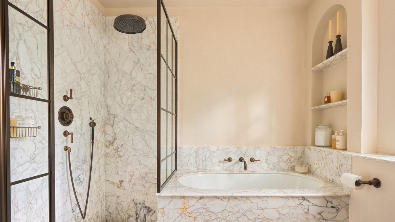 A bathroom with a shower, a plunge bath, and a built-in arched shelving niche 
