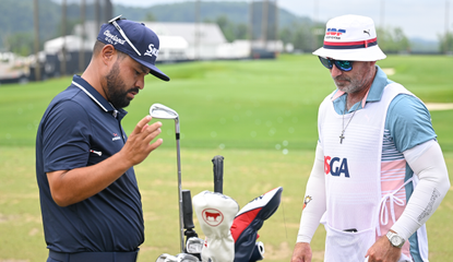 JJ Spaun and his caddie go through the golf bag during the US Open