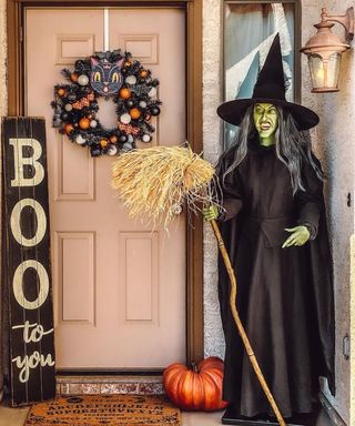 Pink door with Halloween wreath with cat plaque, Boo door sign, ouija board mat, pumpkin and witch figurine