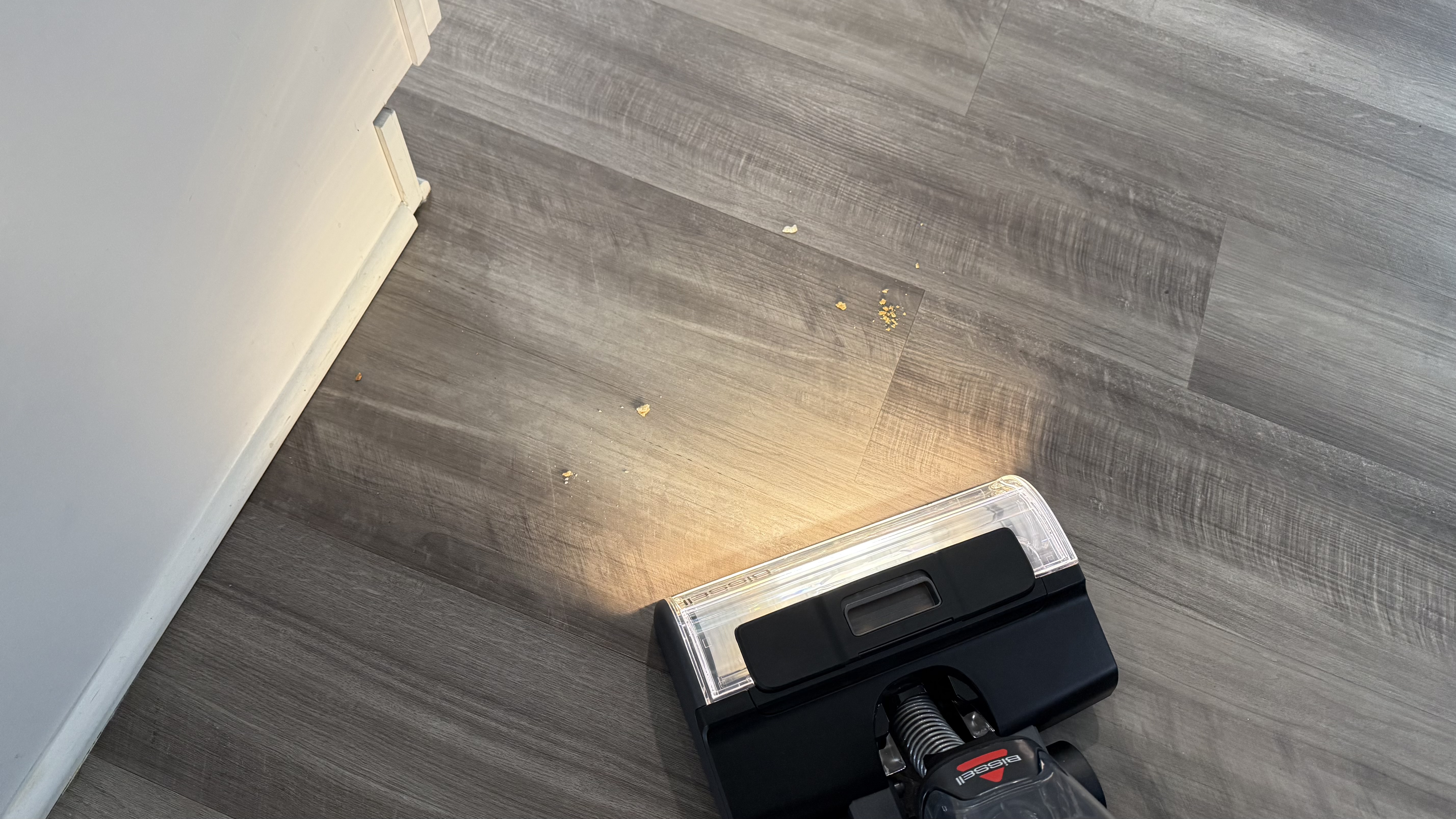 Bissell CrossWave HydroScrub All-in-One-Multi-Surface Cleaner vacuuming up crumbs