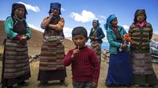 A Tibetan child with several women