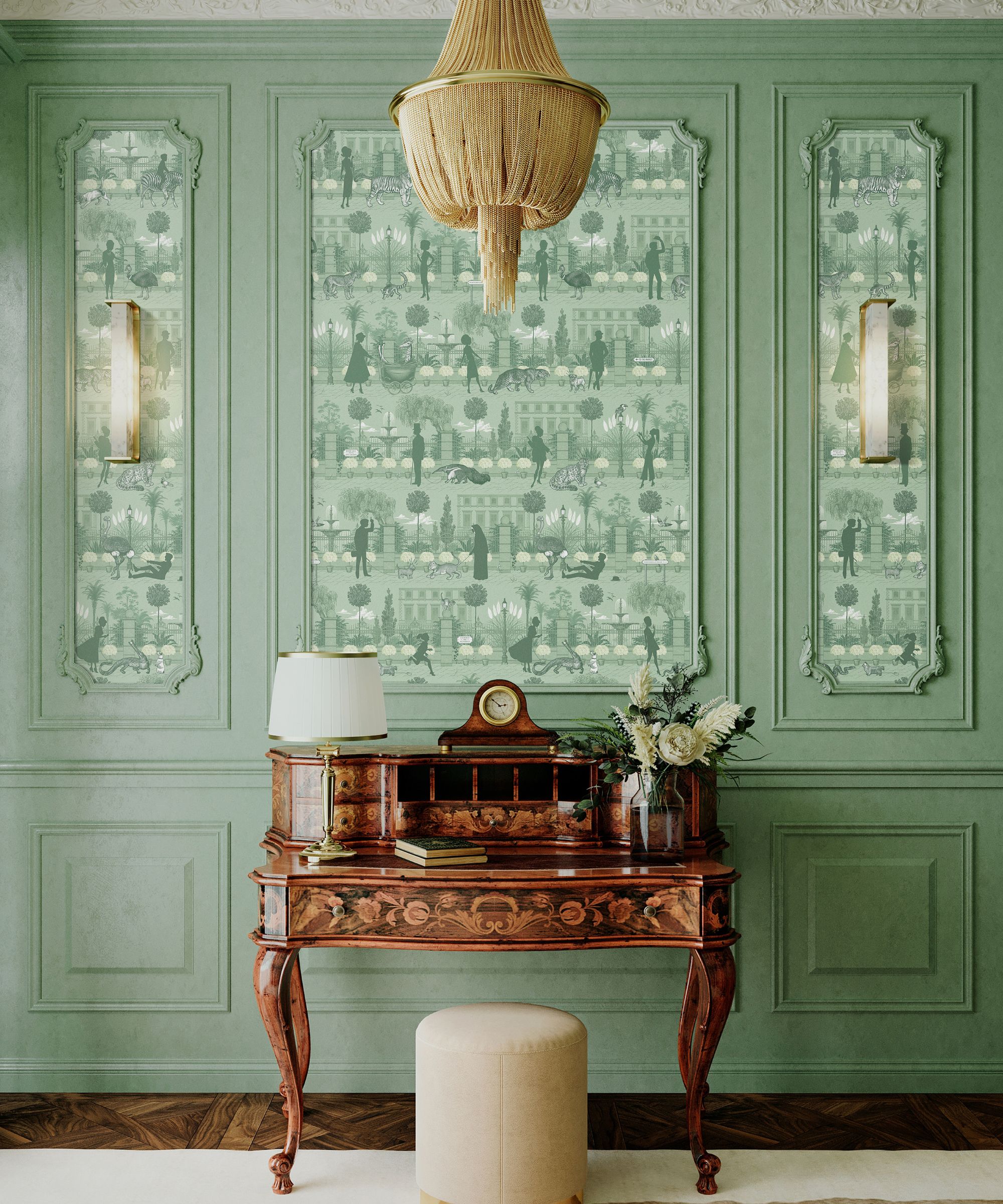 Elegant hallway with pale green panelled walls and wallpaper featuring a garden scene in matching tones. A carved wooden writing desk with a lamp and flowers sits beneath a gold fringe chandelier.