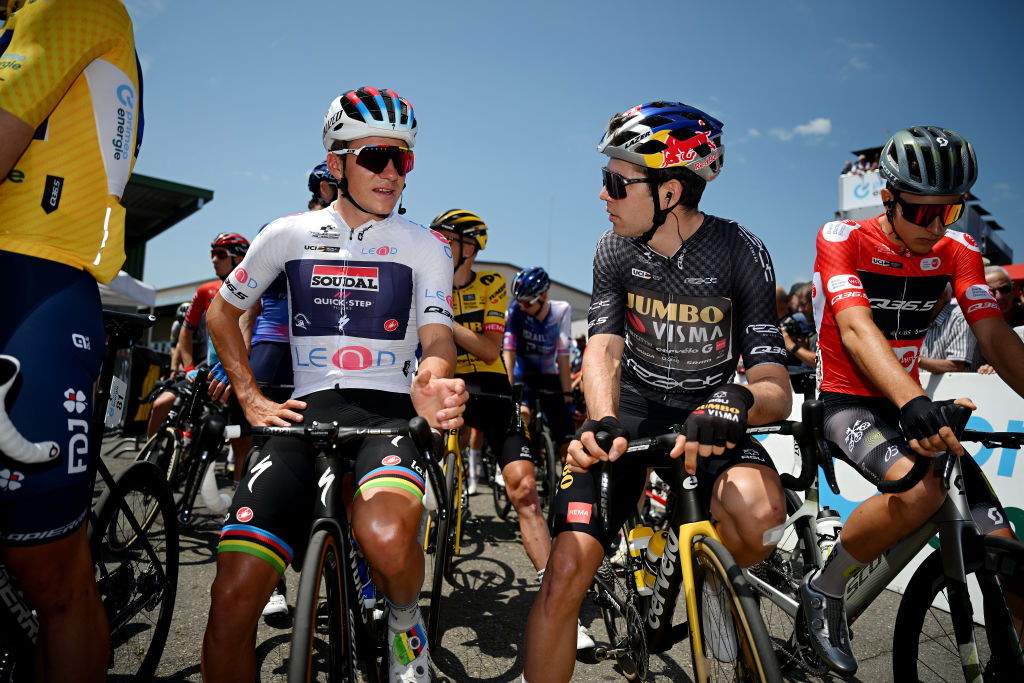 TAFERS SWITZERLAND JUNE 13 LR Remco Evenepoel of Belgium and Team Soudal QuickStep White best young jersey Wout Van Aert of Belgium and Team JumboVisma Black points jersey and Nickolas Zukowsky of Canada and Q365 Pro Cycling Team Red Mountain Jersey prior to the 86th Tour de Suisse 2023 Stage 3 a 1438km stage from Tafers to VillarssurOllon 1256m UCIWT on June 13 2023 in Tafers Switzerland Photo by Dario BelingheriGetty Images