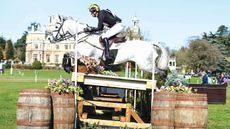 Tom Rowland and Dreamliner clear a table on the cross-country at Thoresby with the house behind.