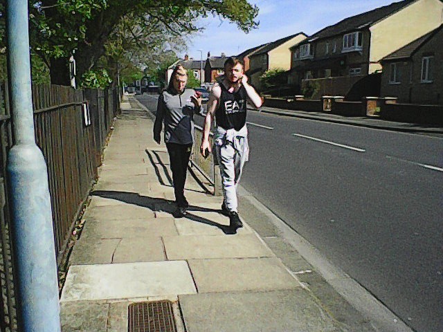 Couple walking in the street on a sunny day
