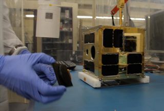 Cordell Grant putting the finishing touches to the first BRITE satellite at UTIAS-SFL. The tiny nanosatellite, designed to study the brightest stars in the night sky, is one of seven spacecraft launching on India's Polar Satellite Launch Vehicle C20 mission on Feb. 25, 2013.
