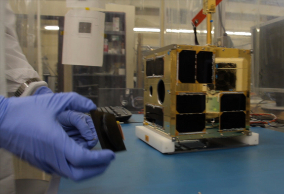 Cordell Grant putting the finishing touches to the first BRITE satellite at UTIAS-SFL. The tiny nanosatellite, designed to study the brightest stars in the night sky, is one of seven spacecraft launching on India's Polar Satellite Launch Vehicle C20 mission on Feb. 25, 2013.
